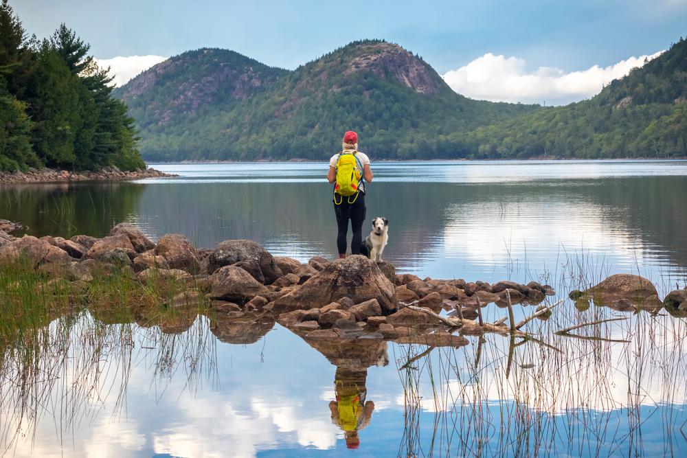  A hiker and her dog at Jordan Pond. (Michael Carni/Shutterstock)