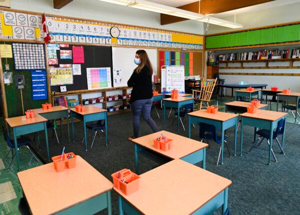 Grade two teacher Vivian Mavraidis walks through her classroom at Hunter's Glen Junior Public School which is part of the Toronto District School Board (TDSB) during the COVID-19 pandemic in Scarborough, Ont., Canada on Sept. 14, 2020. (Nathan Denette/The Canadian Press)