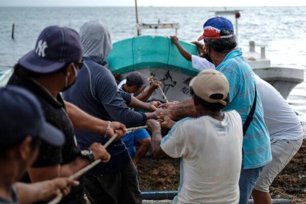 Fishermen pull in a boat before the arrival of Hurricane Delta in Puerto Juarez, Cancun, Mexico, on Oct. 6, 2020. (Victor Ruiz Garcia/AP Photo)
