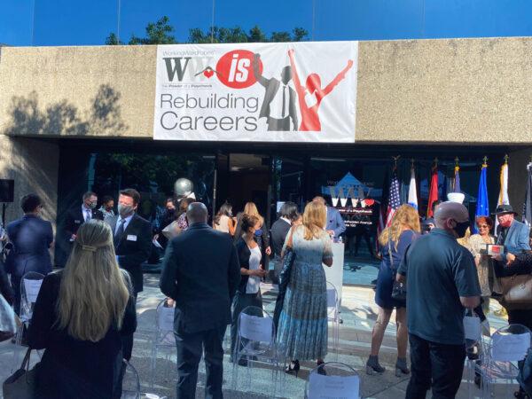 A crowd lingers at the reopening of Working Wardrobes, a center that provides clothing and training to the needy, in Santa Ana, Calif., on Sept. 30, 2020. (Jack Bradley/The Epoch Times)