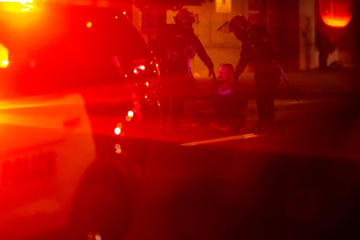 Police arrest a man during a riot in Portland, Ore., Oct. 7, 2020. (Nathan Howard/Getty Images)