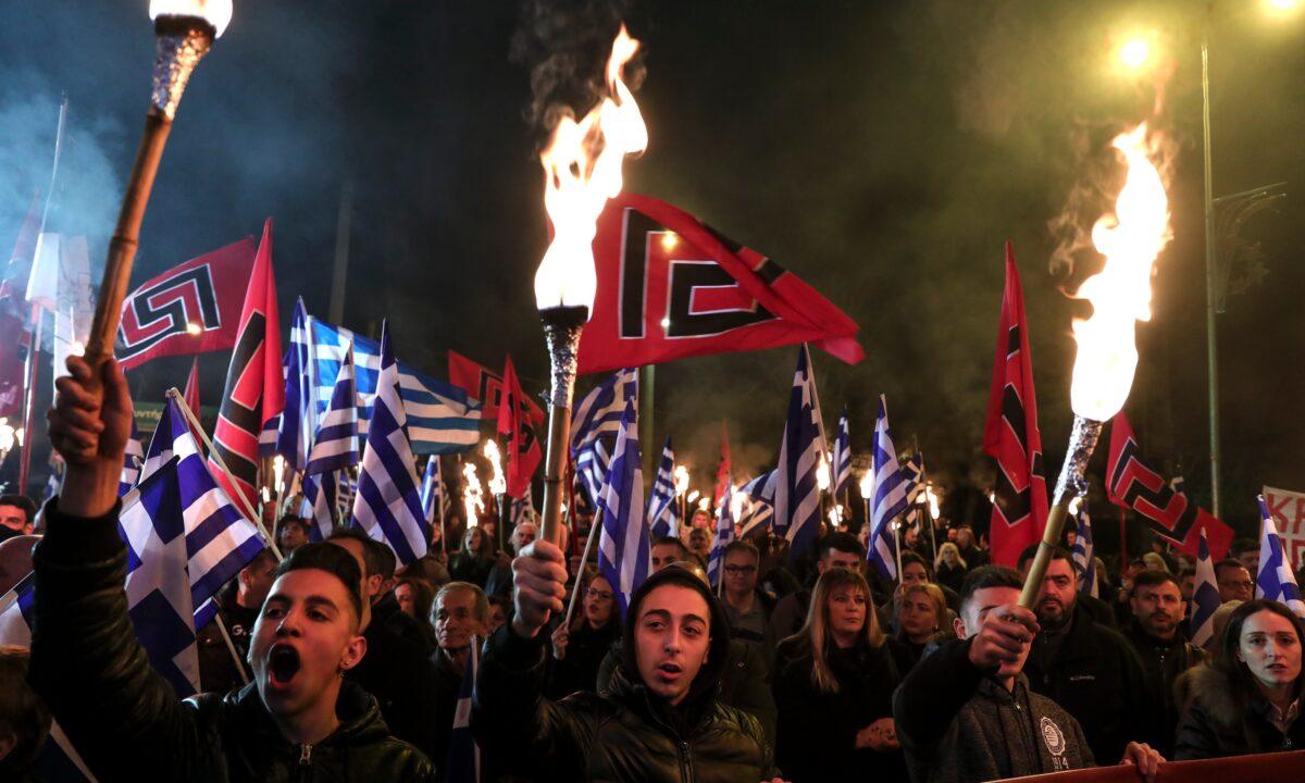 Supporters of Golden Dawn raise torches during a rally commemorating a 1996 military incident that cost the lives of three Greek navy officers and brought Greece and Turkey to the brink of war, in Athens, on Feb. 2, 2019. (Yorgos Karahalis/AP Photo)