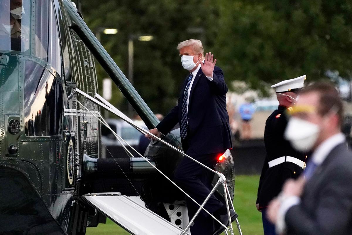 President Donald Trump boards Marine One at Walter Reed National Military Medical Center after receiving treatment for COVID-19, in Bethesda, Md., Oct. 5, 2020. (Evan Vucci/AP Photo)