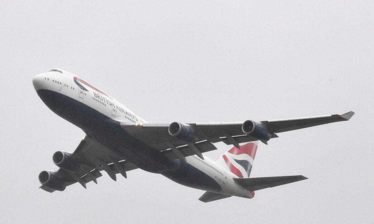 A British Airways Boeing 747 does a flypast over London Heathrow airport on its final flight, the last of 31 jumbo jets to be retired early by the airline due to the coronavirus disease (COVID-19) pandemic, in London, Britain, on Oct. 8, 2020. (Toby Melville/Reuters)