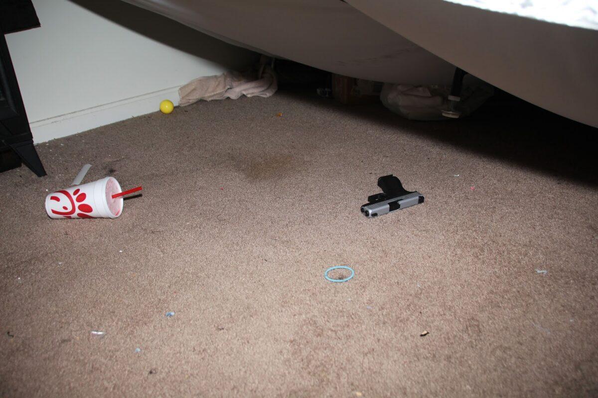 The gun fired by Kenneth Walker, Breonna Taylor's boyfriend, sits under a bed inside Taylor's apartment in Louisville, Ky., on March 13, 2020. (Louisville Metro Police Department)