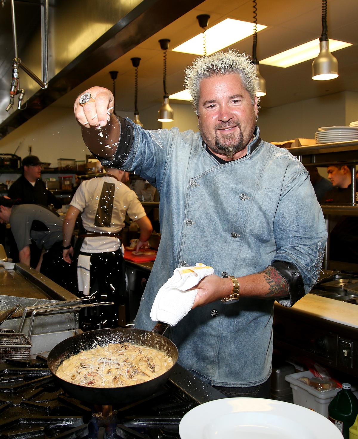 Fieri prepares a meal at his restaurant, Guy Fieri's Mt. Pocono Kitchen, during a meet and greet at Mount Airy Casino Resort in Mount Pocono, Pa., on July 30, 2016. (Paul Zimmerman/Getty Images)