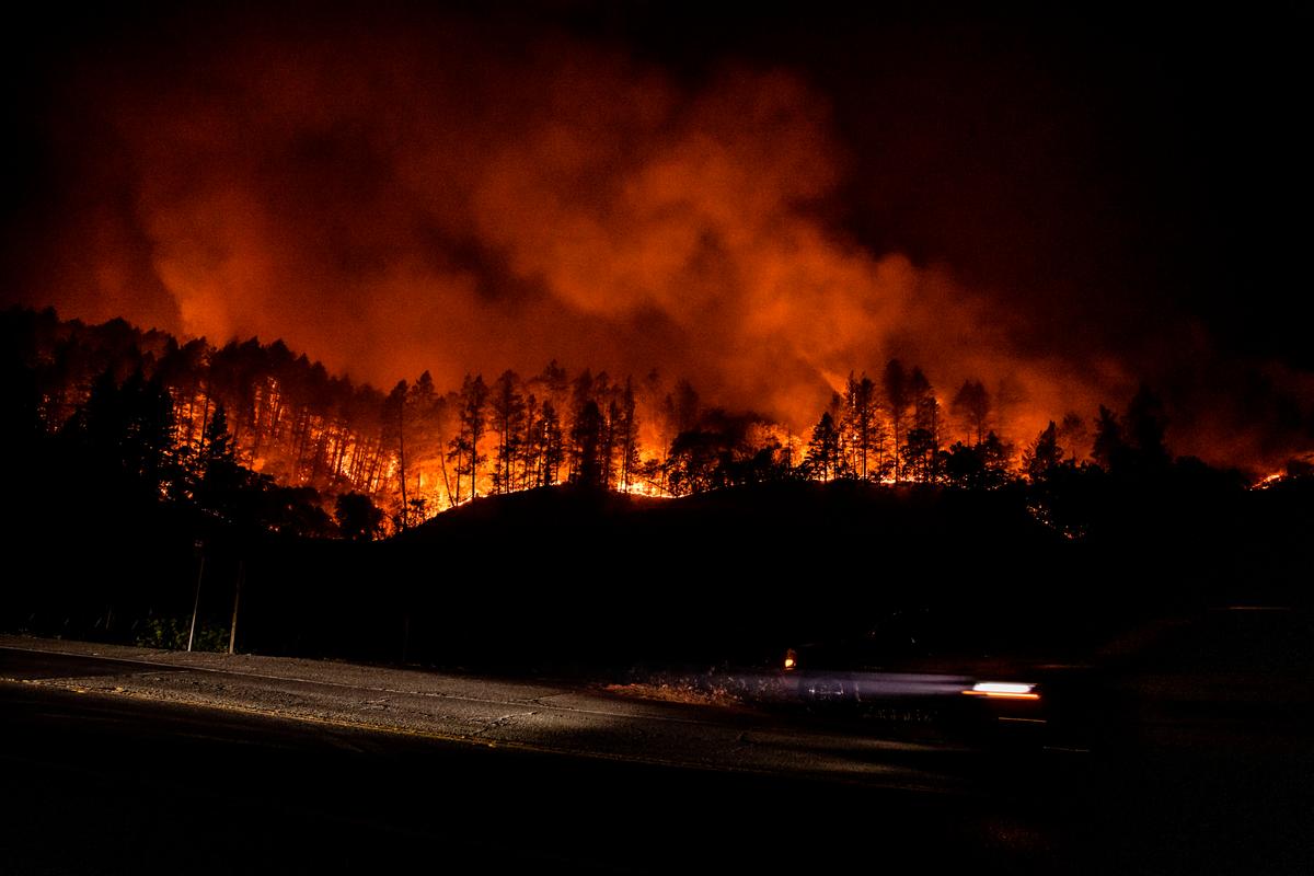 The Glass Incident Fire crests the ridge outside of Calistoga in Napa Valley, Calif., on Sept. 28, 2020 (SAMUEL CORUM/AFP via Getty Images)