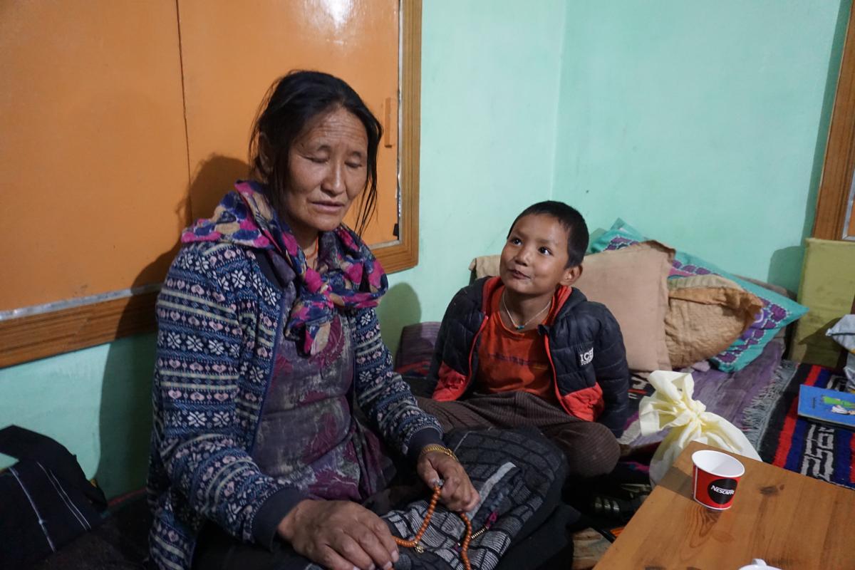Deceased Tibetan soldier Nyima Tenzin's wife, Nyima Lhamo, with their 5-year-old son, Tenzin Goyalgsen, in their home in a Tibetan refugee camp in Leh, India, on Oct. 9, 2020. (Venus Upadhayaya/Epoch Times)