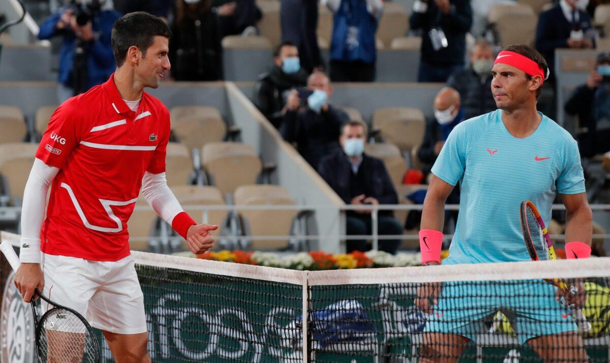 Serbia's Novak Djokovic (L) and Spain's Rafael Nadal look at each other as they pose for images prior to the final match of the French Open tennis tournament at the Roland Garros stadium in Paris, France, on Oct. 11, 2020. (Michel Euler/AP Photo)