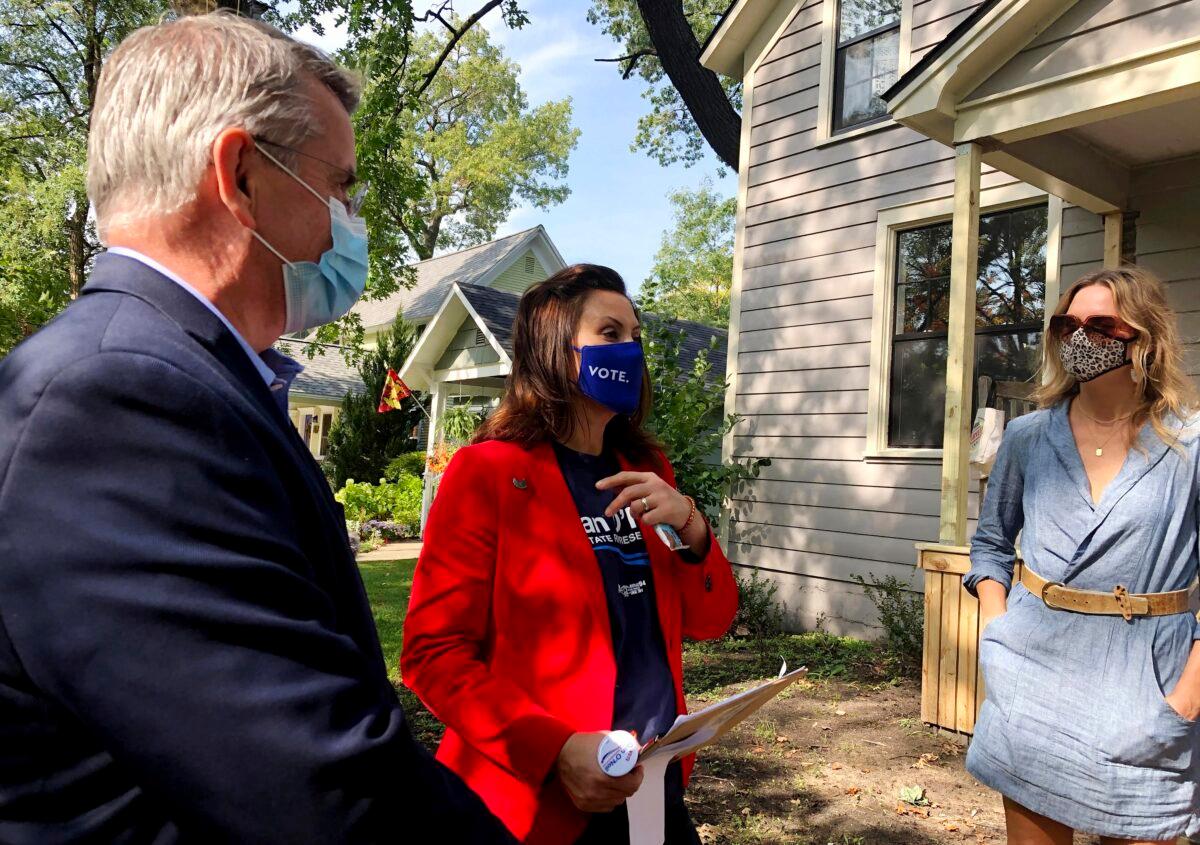 Michigan Gov. Gretchen Whitmer, center, and legislative candidate Dan O'Neil, left, greet Rachel White in Traverse City, Mich., Oct. 9, 2020. Whitmer visited the area the day after police announced a foiled plot to kidnap the governor. (John Flesher/AP Photo)