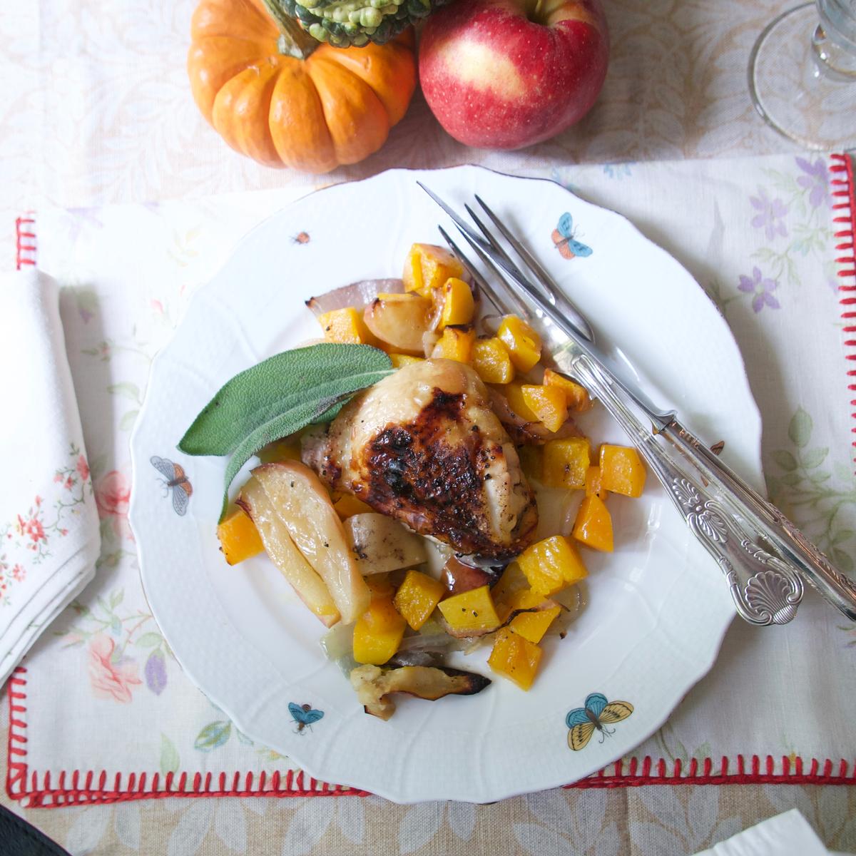 As the chicken thighs roast, they release their juices and fat to mingle with the caramelizing squash and apples on the same pan. (Victoria de la Maza)