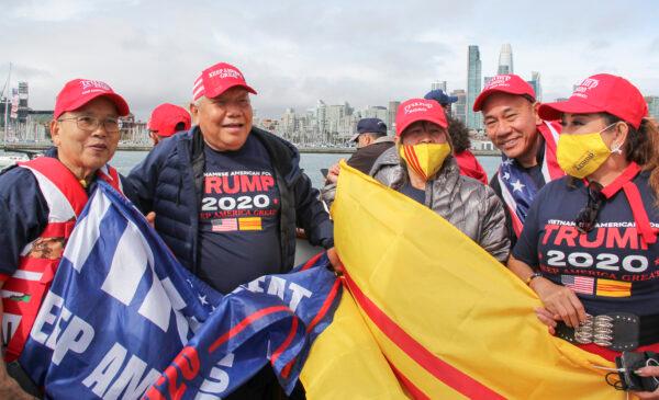 Ha Trieu (2nd L) shows his support for President Donald Trump at a boat parade in San Francisco on Oct. 10. (David Lam/The Epoch Times)