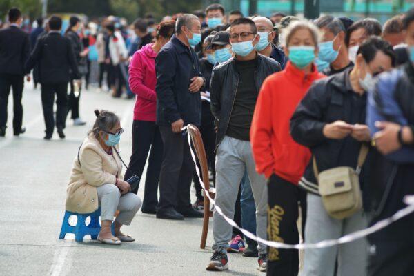 Residents wait to be tested for the COVID-19 in Qingdao, eastern China’s Shandong Province on Oct. 12, 2020. (STR/AFP via Getty Images)