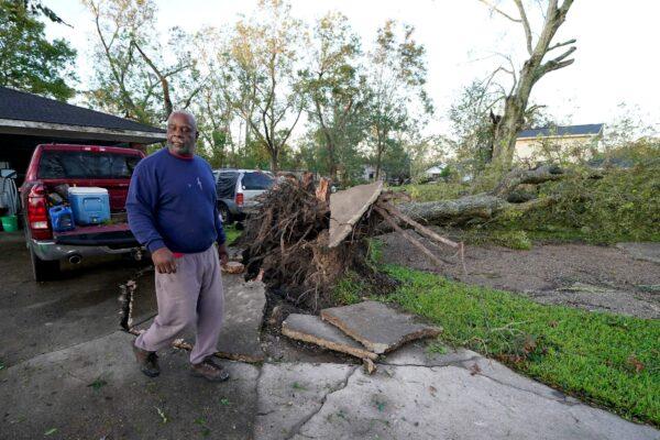 Marcus Peterson walks past a downed tree in his yard after Hurricane Delta moved through, in Jennings, La, on Oct. 10, 2020. (Gerald Herbert/AP Photo)