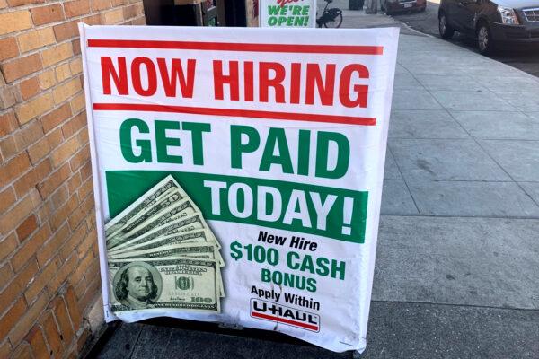 A “Now Hiring” sign stands outside a U-Haul store on Bryant Street in San Francisco, on Sept. 19, 2020. (David Zhang/The Epoch Times)