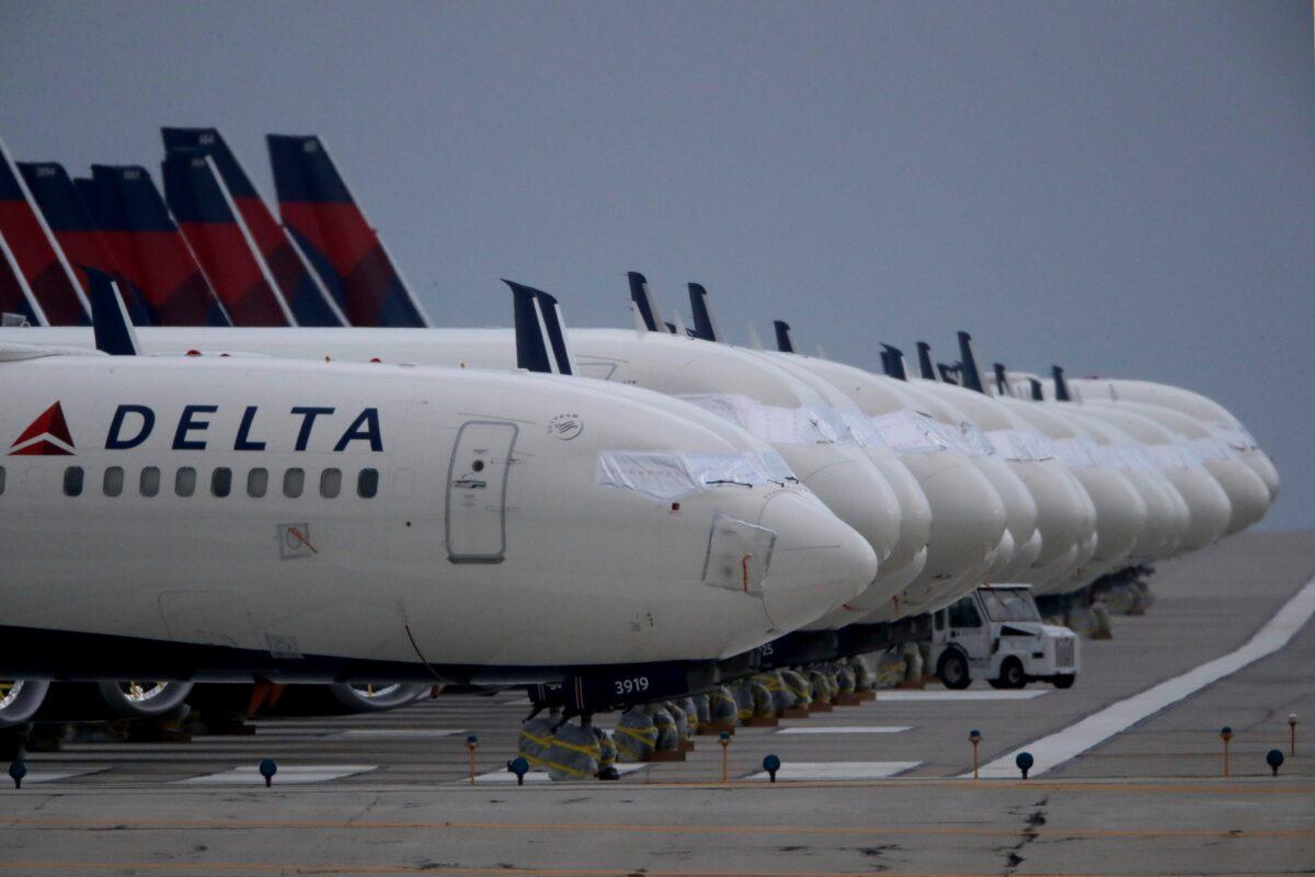 Several dozen mothballed Delta Air Lines jets are parked on a closed runway at Kansas City International Airport in Kansas City, Mo., on May 14, 2020. (Charlie Riedel/AP Photo)