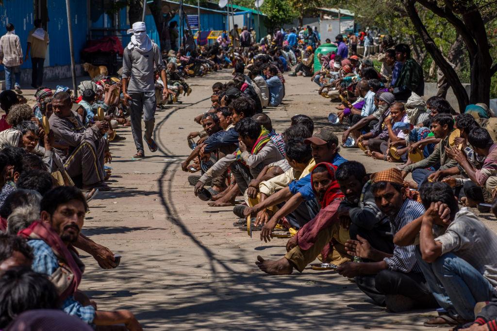 Indian migrant workers, laborers, and homeless people wait for food outside a government-run shelter in New Delhi, India, on March 28, 2020 (Yawar Nazir/Getty Images)