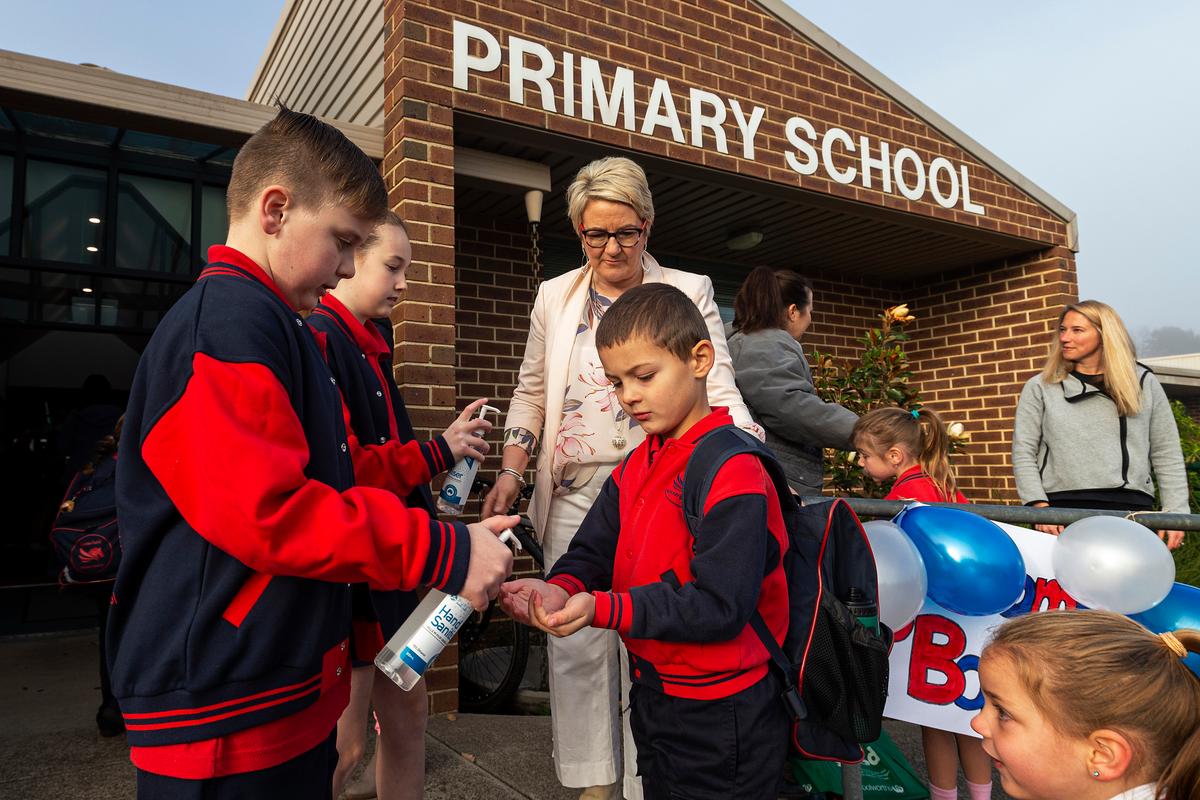 Students sanitize before entering for the first day back at Lysterfield Primary School in Melbourne, Australia, on May 26, 2020. (Daniel Pockett/Getty Images)