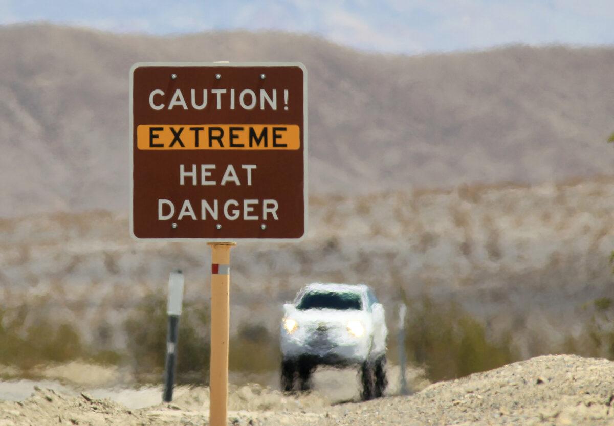 Heat waves rise near a warning sign on in Death Valley National Park, on July 14, 2013. (David McNew/Getty Images)