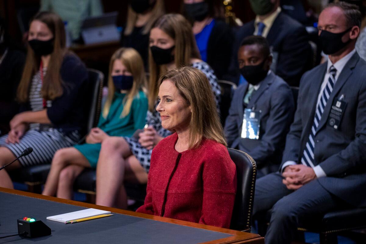  Supreme Court nominee Amy Coney Barrett speaks during a confirmation hearing before the Senate Judiciary Committee on Capitol Hill in Washington, as her family members watch, Oct. 13, 2020. (Shawn Thew/Pool via AP)