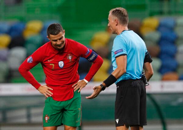 Portugal's Cristiano Ronaldo (L) reacts as he speaks with referee Paolo Valeri during the international friendly soccer match between Portugal and Spain at the Jose Alvalade stadium in Lisbon on Oct. 7, 2020. (Armando Franca/AP/File)