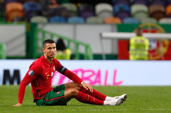 Portugal's Cristiano Ronaldo sits on the pitch during the international friendly soccer match between Portugal and Spain at the Jose Alvalade stadium in Lisbon on Oct. 7, 2020. (Armando Franca/AP/File)