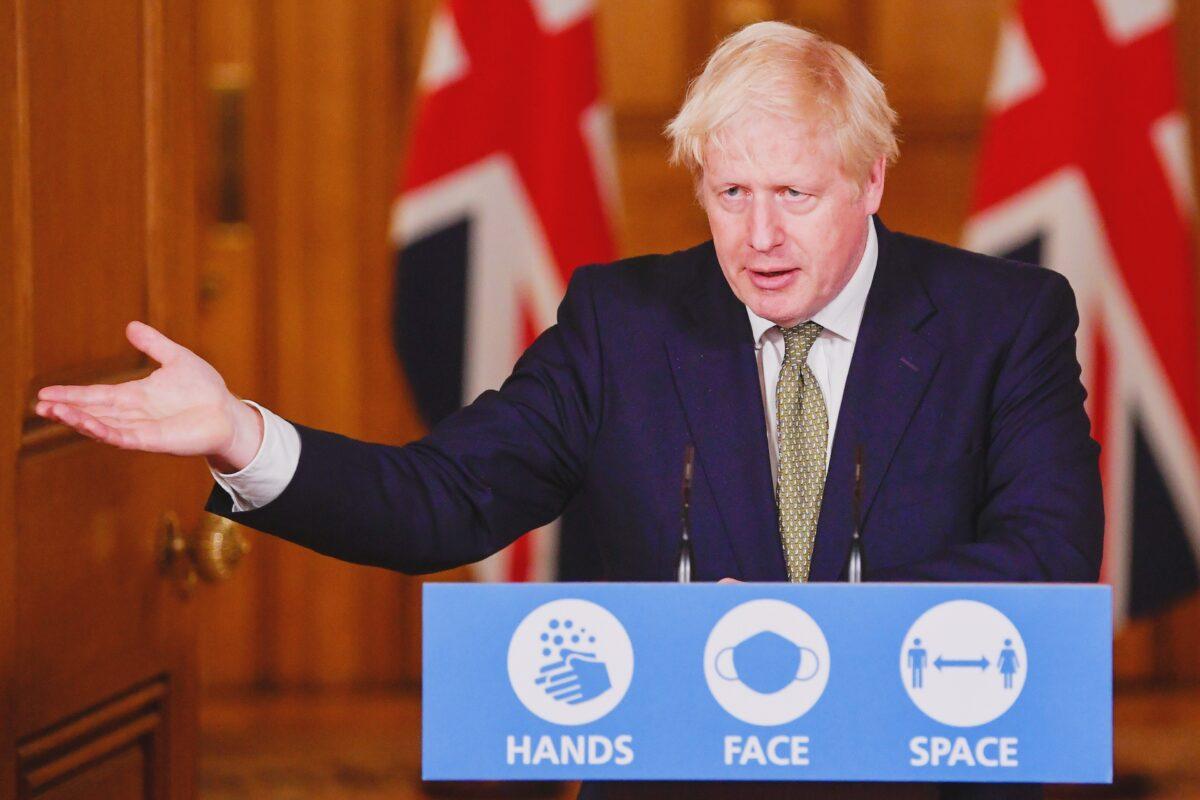 Britain's Prime Minister Boris Johnson gestures as he speaks during a virtual news conference on the ongoing situation with the CCP virus, at Downing Street, London, on Oct. 12, 2020. (Toby Melville/Pool via Reuters)