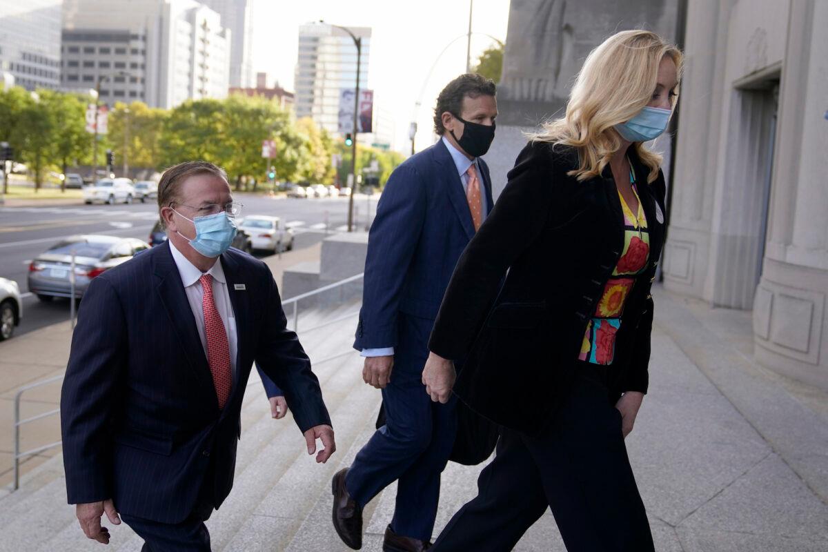 Mark and Patricia McCloskey arrive for a court hearing along with their attorney Joel Schwartz, center, in St. Louis, Mo., on Oct. 14, 2020. (Jeff Roberson/AP Photo)