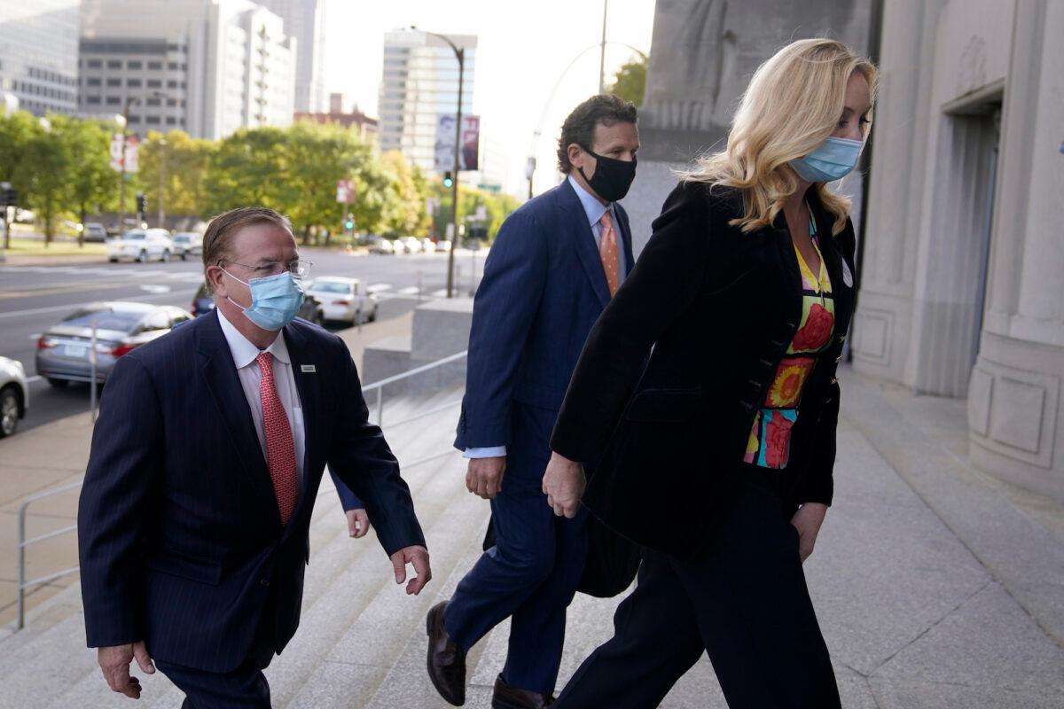 Mark and Patricia McCloskey arrive for a court hearing along with their attorney Joel Schwartz, center, in St. Louis, Mo., on Oct. 14, 2020. (Jeff Roberson/AP Photo)