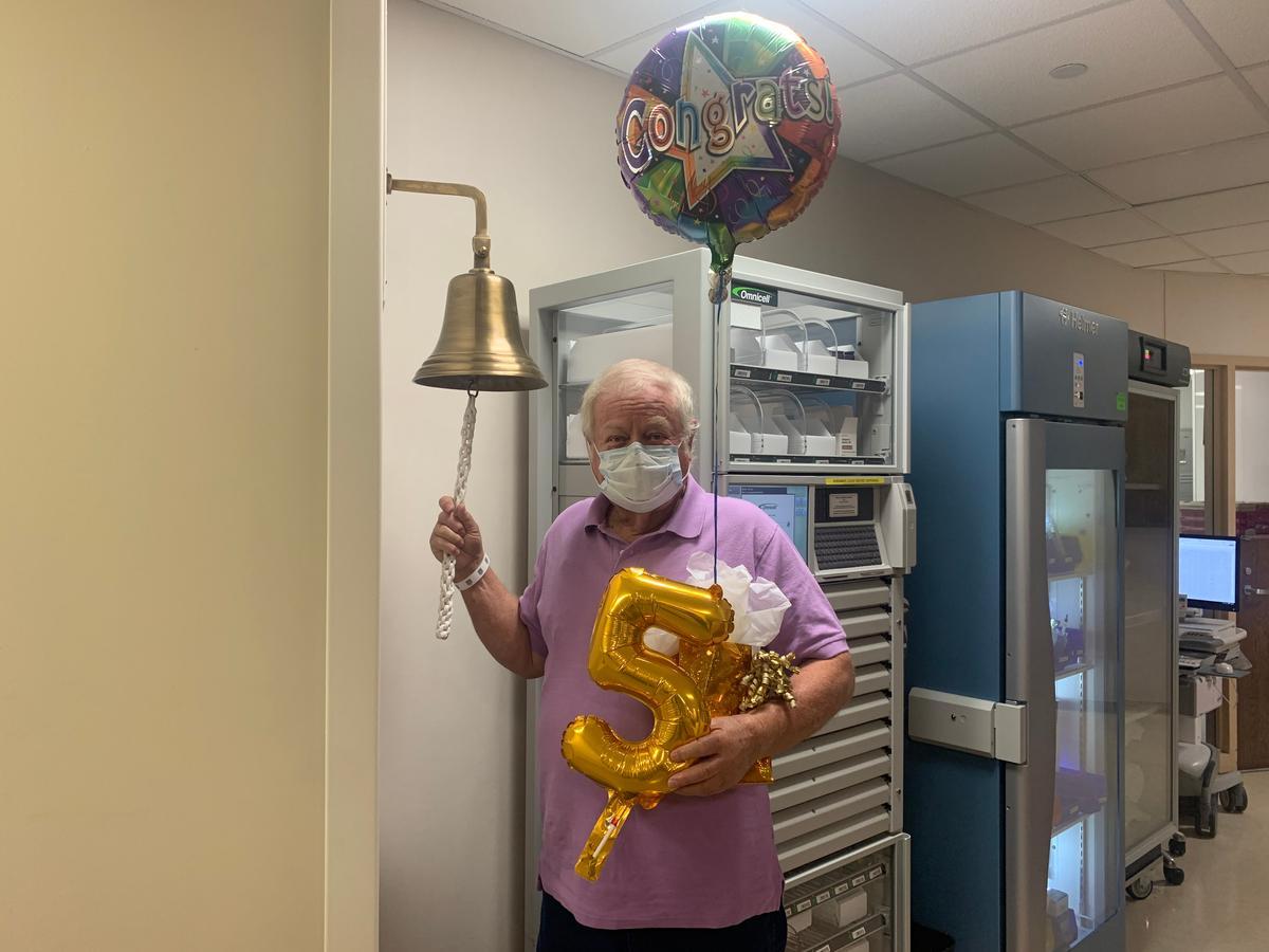 Pancreatic cancer patient Earl Groce ringing the victory bell (Courtesy of <a href="https://newsroom.wakehealth.edu/News-Releases/2020/10/Man-Rings-Victory-Bell-to-Mark-5-Year-Survival-of-Stage-IV-Pancreatic-Cancer">Wake Forest Baptist Health</a>)