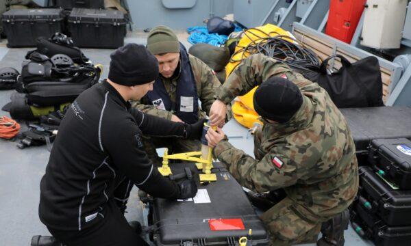 Navy divers from the 12th Minesweeper Squadron of the 8th Coastal Defense Flotilla take part in an operation to defuse the largest unexploded World War Two Tallboy bomb ever found in Poland, in Swinoujscie, Poland, on Oct. 12, 2020. (8 Flotylla Obrony Wybrzeza/Handout via Reuters)