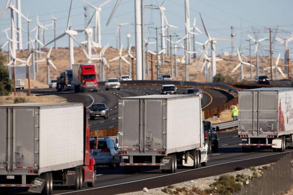 Diesel trucks and cars pass windmills along the 10 freeway near Banning, Calif., on Dec. 8, 2009. (David McNew/Getty Images)