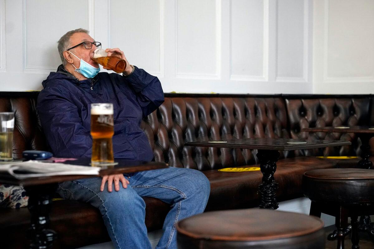 A man drinks beer in a Liverpool city centre pub ahead of the lockdown closure of bars, gyms, and clubs, in Liverpool, England, on Oct. 13, 2020. (Christopher Furlong/Getty Images)