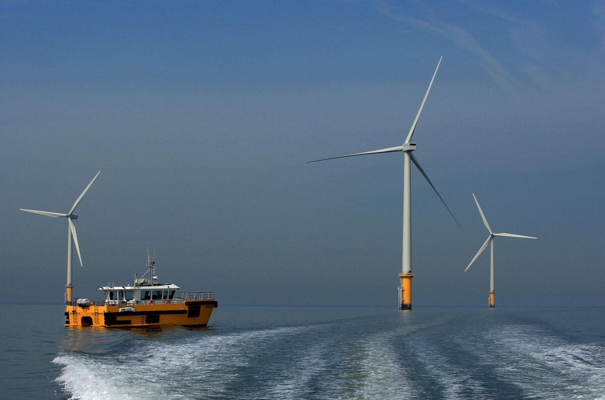 A maintenance boat works next to the turbines of the new Burbo Bank offshore wind farm in the mouth of the River Mersey on May 12, 2008, in Liverpool, England. (Christopher Furlong/Getty Images)