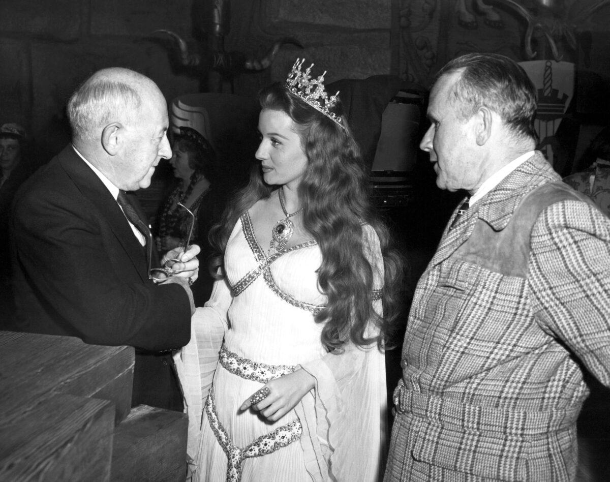 Producer-director Cecil B. DeMille gives Actress Rhonda Fleming some advice from a veteran movie man, and Tay Garnett listens, in Hollywood, Calif., on Dec. 16, 1947. (AP Photo)