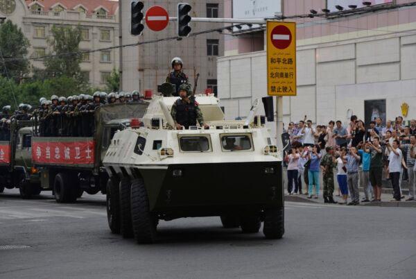 Chinese paramilitary police ride in trucks and an armoured personnel carrier during a 'show of force' ceremony in Urumqi, northwestern China’s Xinjiang province on June 29, 2013. (Mark Ralston/AFP via Getty Images)