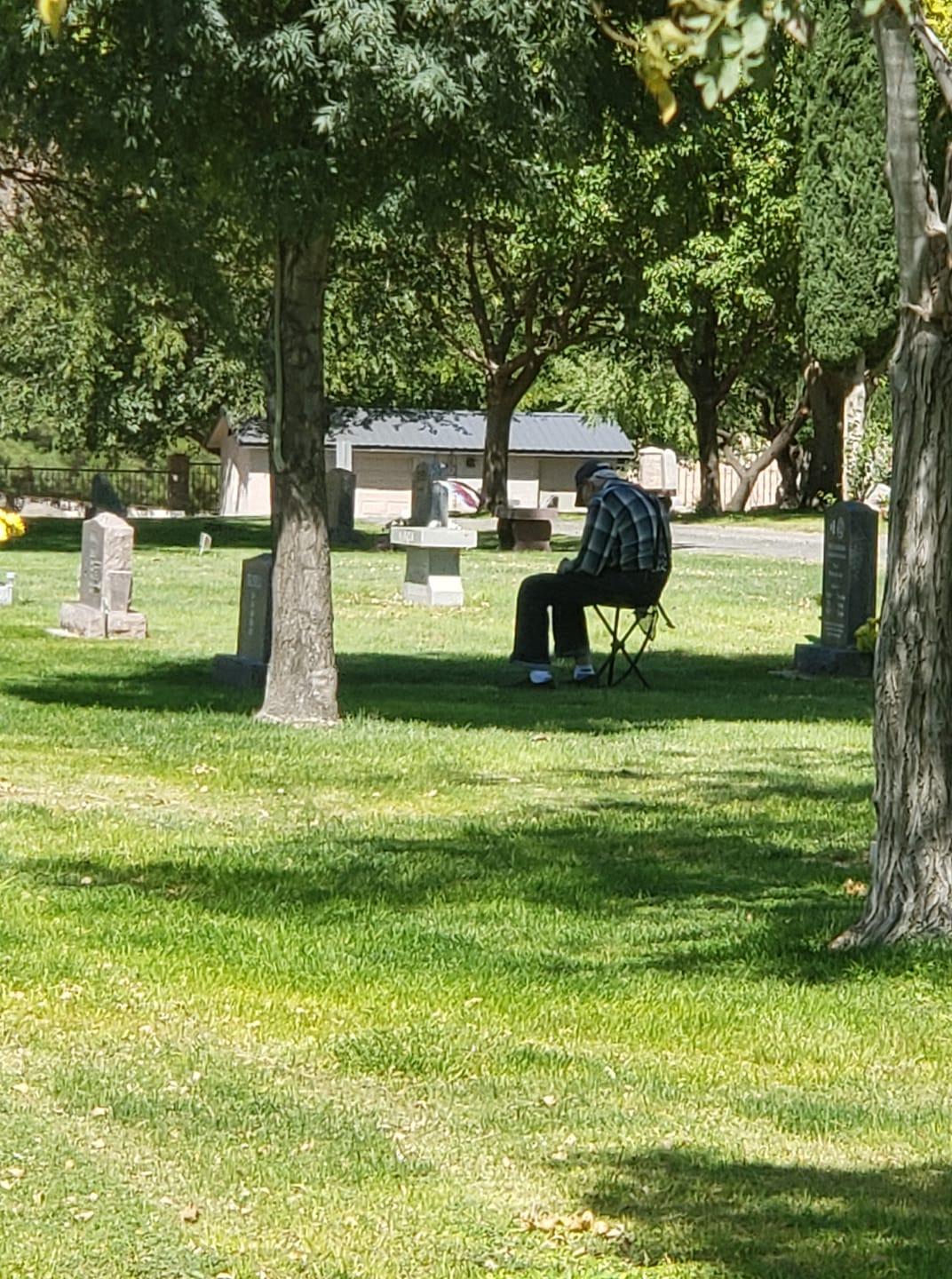 Mr. Lee sitting by his wife's grave in Toquerville, Utah (Courtesy of <a href="https://www.facebook.com/erik.largin">Erik Largin</a>)