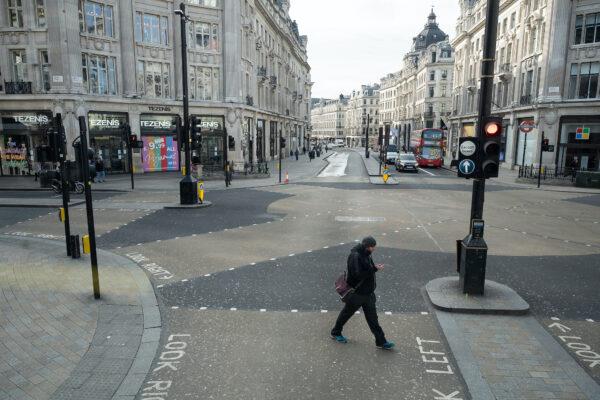 A man walks across a quiet Oxford Circus in London on March 20, 2020. (Leon Neal/Getty Images)
