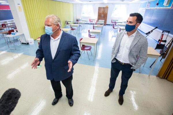 Ontario Premier Doug Ford (L) and Education Minister Stephen Lecce take a tour of a school in Toronto on Sept. 1, 2022. (The Canadian Press/Carlos Osorio)