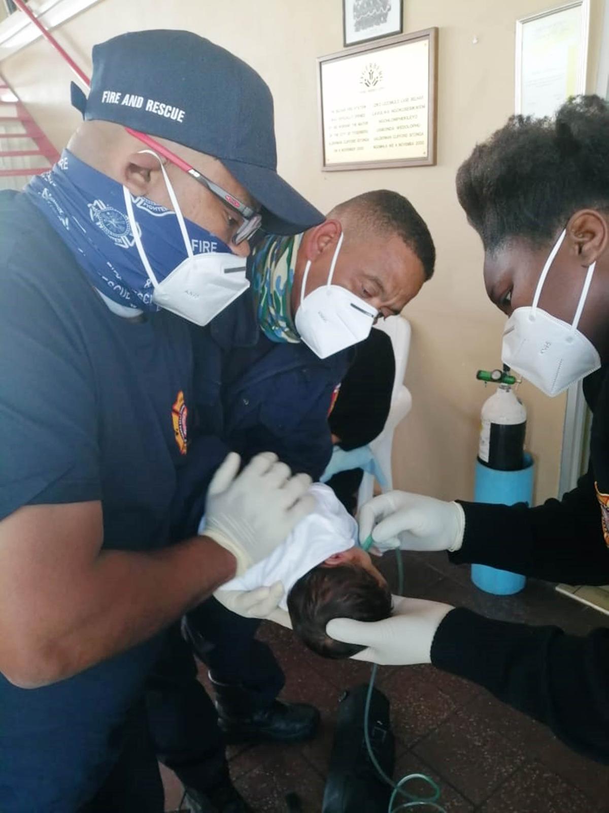  Crew members from the Belhar Fire Station try to resuscitate the two-week-old baby on Oct. 9, 2020. (Courtesy of <a href="https://www.facebook.com/CityofCT/">City of Cape Town</a>)