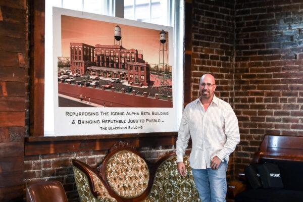 Businessman Ryan McWilliams stands by a rendering of one of his projects in Pueblo, Colo., on Sept. 29, 2020. (Charlotte Cuthbertson/The Epoch Times)