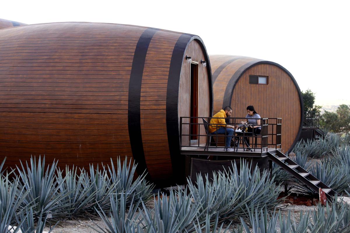 A couple enjoys at one of many barrel-shaped rooms that make up a hotel in Tequila, Jalisco state, Mexico, on March 22, 2019. (ULISES RUIZ/AFP via Getty Images)