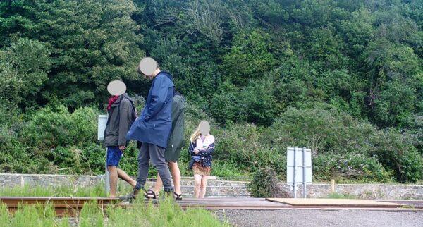 CCTV captures a group walking along the track at Harlech, Wales, on an unspecified date in summer 2020. (Network Rail)