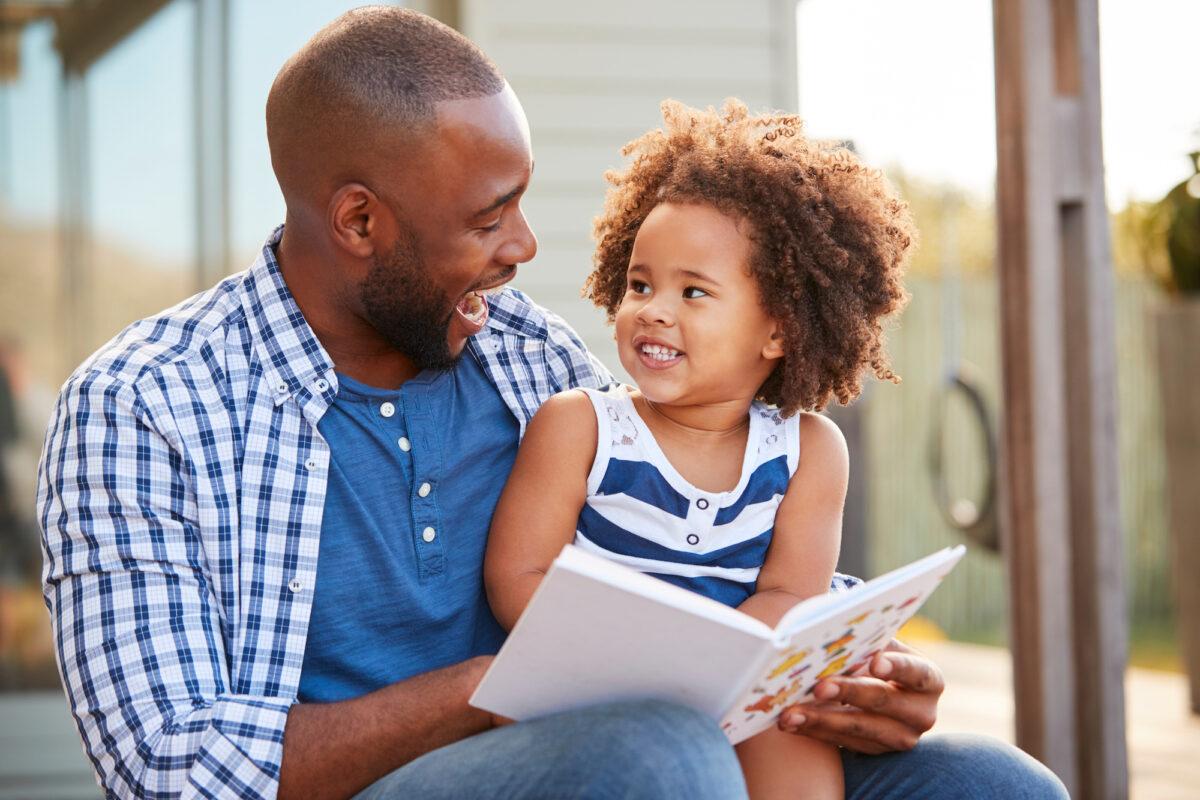 A father reads to his daughter in this file photo. (Monkey Business Images/Shutterstock)