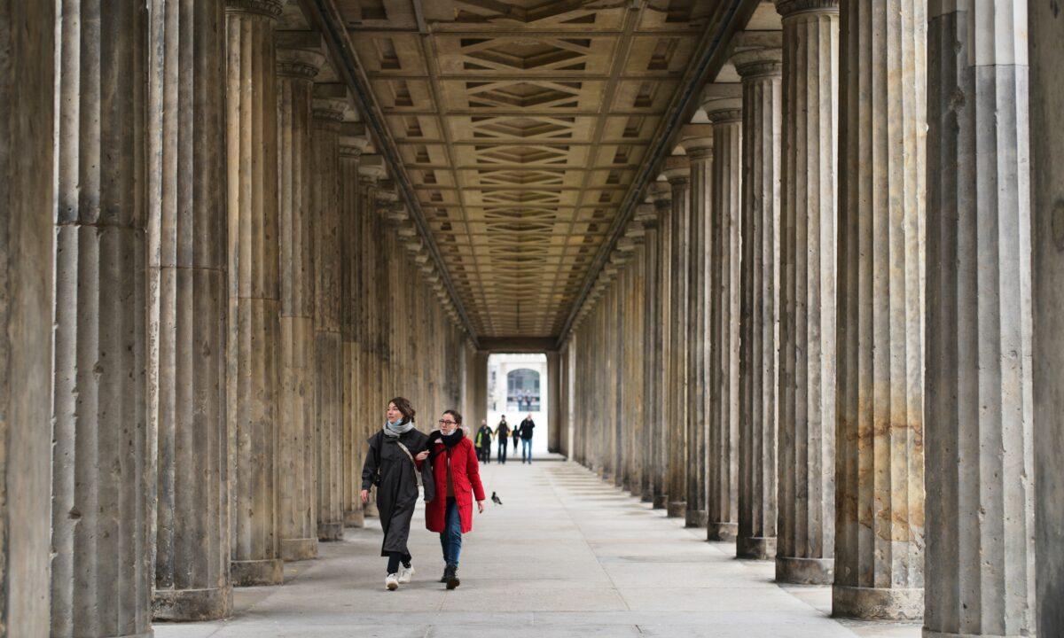 People walk through a colonnade in the Museums Island in Berlin, on Oct. 21, 2020. A large number of artworks and artifacts at some of Berlin's best-known museums were smeared with a liquid by an unknown perpetrator or perpetrators earlier this month, police said Wednesday. The 'numerous' works in several museums at the Museum Island complex, a UNESCO world heritage site in the heart of the German capital that is one of the city's main tourist attractions, were targeted on Oct. 3, police said. (Markus SchreiberAP Photo)