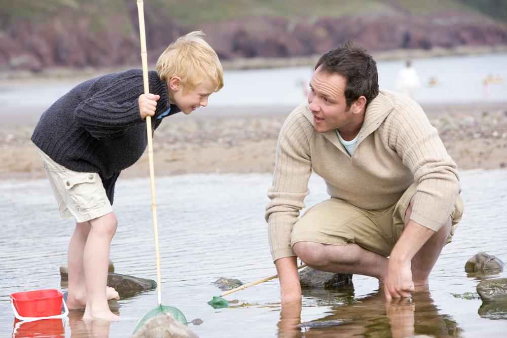Father and son fish at the beach. (Monkey Business Images/Shutterstock)