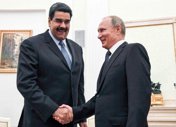 Russian President Vladimir Putin (R) shakes hands with Venezuela's President Nicolas Maduro during a meeting at the Kremlin in Moscow on Oct. 4, 2017. (Yuri Kadobnov/The Canadian Press)