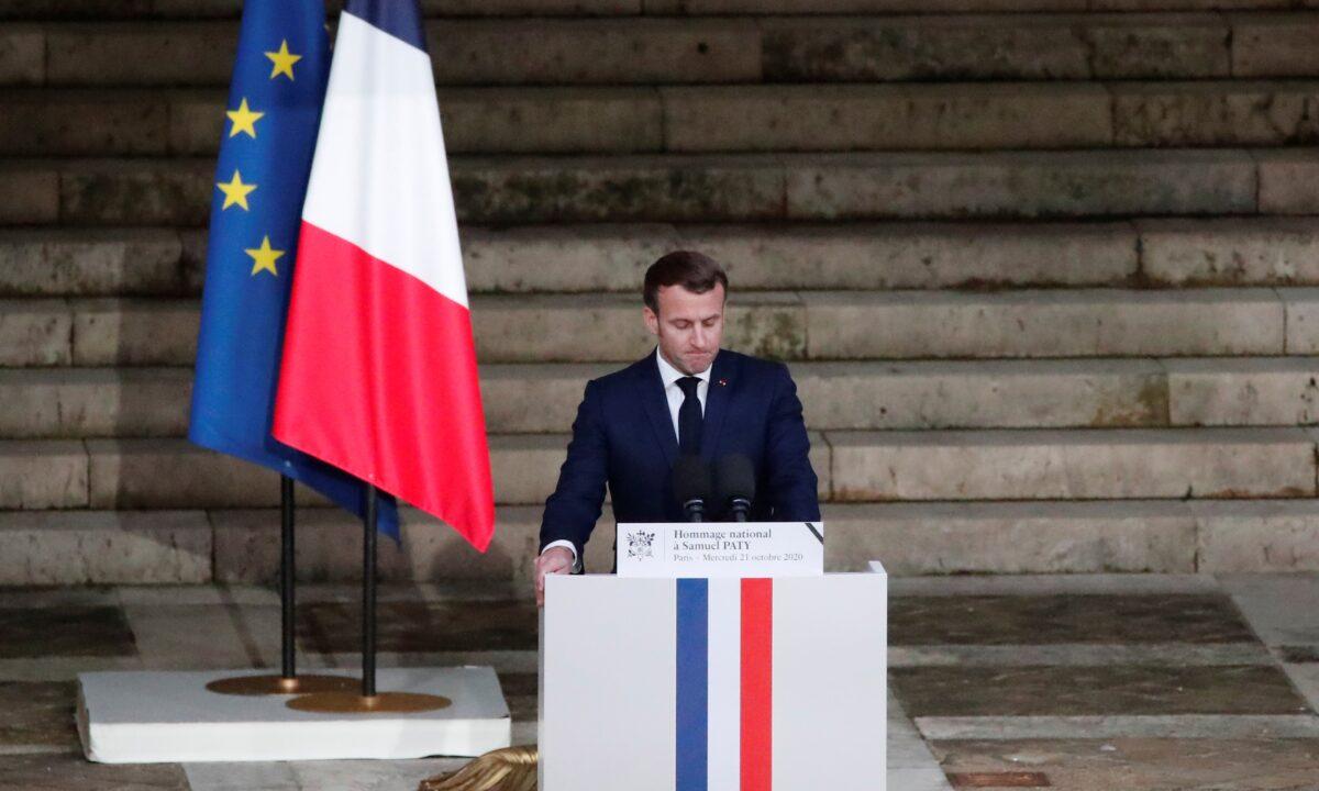 French President Emmanuel Macron delivers his speech in front of the coffin of slain teacher Samuel Paty during a national memorial event, in Paris, France, on Oct. 21, 2020. (Francois Mori/Pool via Reuters)