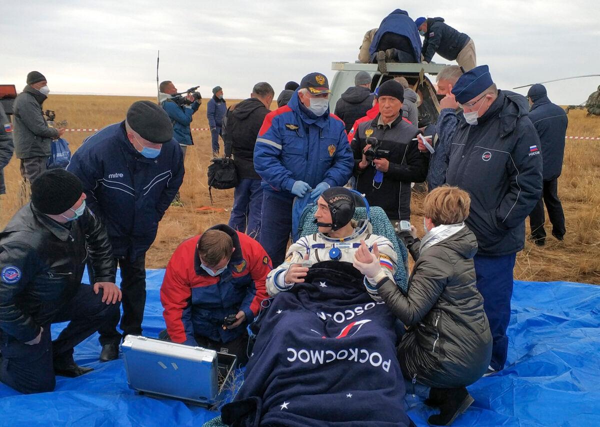 Roscosmos' cosmonaut Anatoly Ivanishin sits in a chair shortly after the landing near town of Dzhezkazgan, Kazakhstan, on Oct. 22, 2020. (Rosaviatsiya via AP)
