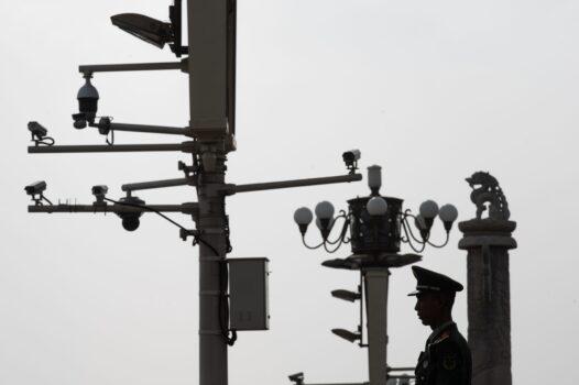 A Chinese paramilitary policeman stands guard before security cameras at Tiananmen Square in Beijing on April 8, 2019. (STR/AFP via Getty Images)